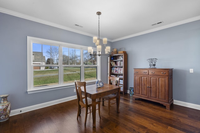 dining space featuring a chandelier, dark hardwood / wood-style floors, and ornamental molding