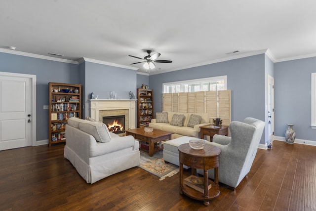 living room with crown molding, ceiling fan, and dark wood-type flooring