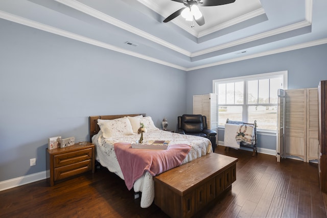 bedroom featuring a raised ceiling, ceiling fan, dark hardwood / wood-style floors, and ornamental molding