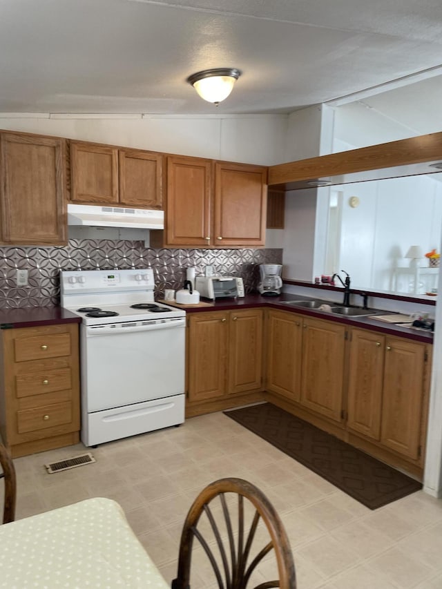 kitchen with tasteful backsplash, sink, white electric range oven, and lofted ceiling