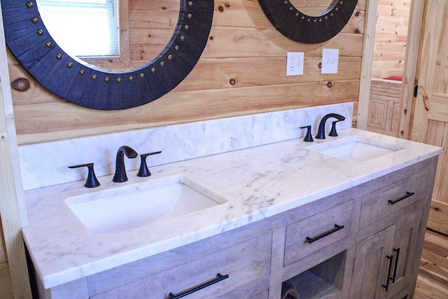 bathroom with a sink and double vanity