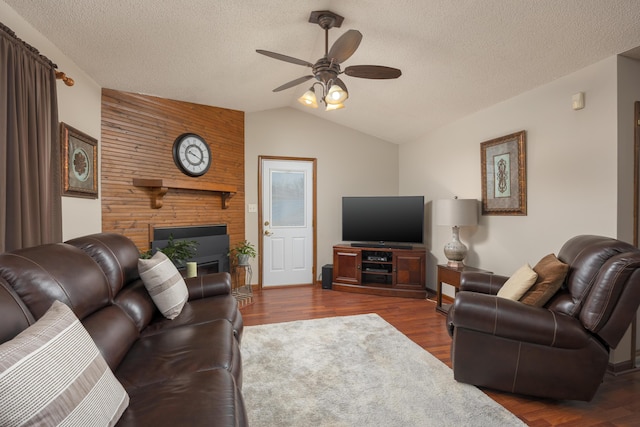 living room featuring dark wood finished floors, a textured ceiling, a ceiling fan, and vaulted ceiling