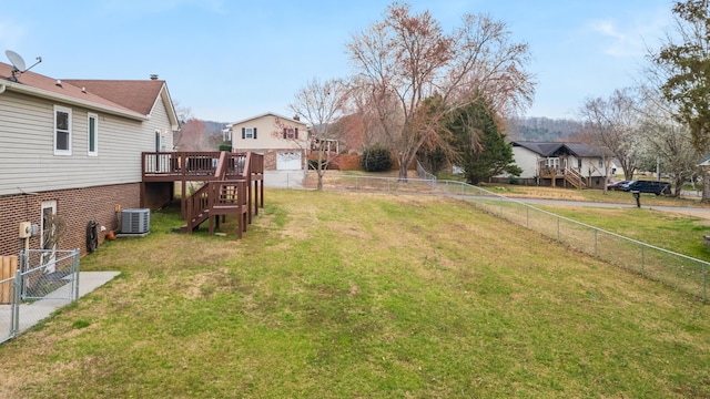 view of yard featuring stairway, a wooden deck, central AC unit, and a fenced backyard