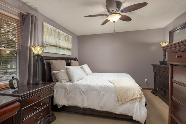 bedroom with light carpet, a textured ceiling, and ceiling fan