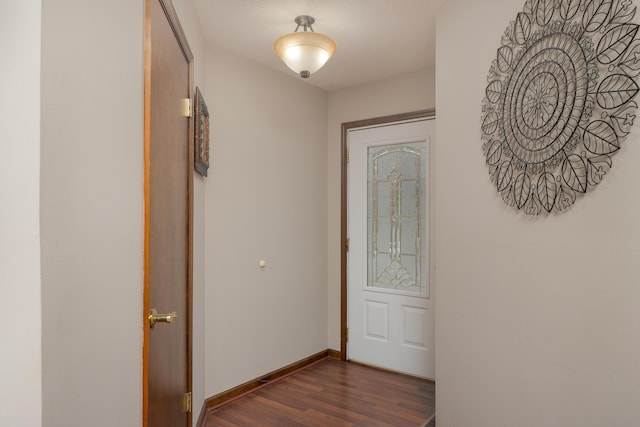 hallway featuring baseboards and dark wood-style floors