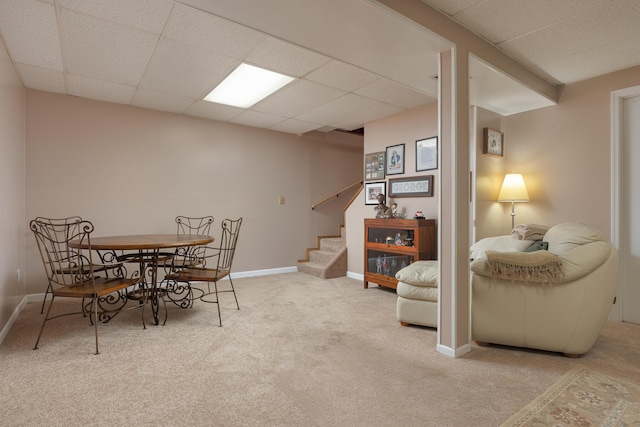 dining room featuring stairs, baseboards, a paneled ceiling, and carpet flooring