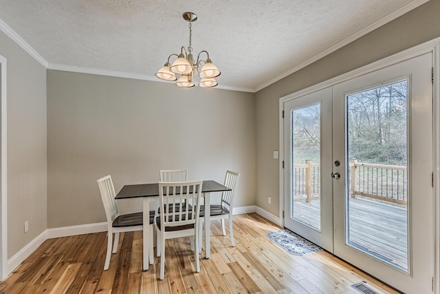 unfurnished dining area with french doors, crown molding, and hardwood / wood-style flooring