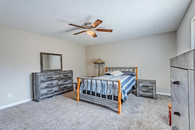 carpeted bedroom with ceiling fan, a textured ceiling, and baseboards