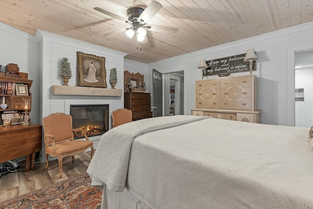 bedroom featuring wood-type flooring, ceiling fan, crown molding, and wood ceiling