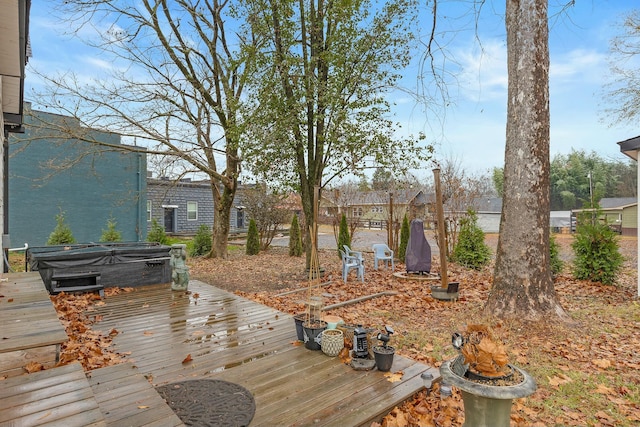 wooden terrace featuring a hot tub