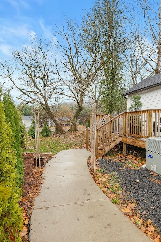 view of yard with cooling unit and a wooden deck