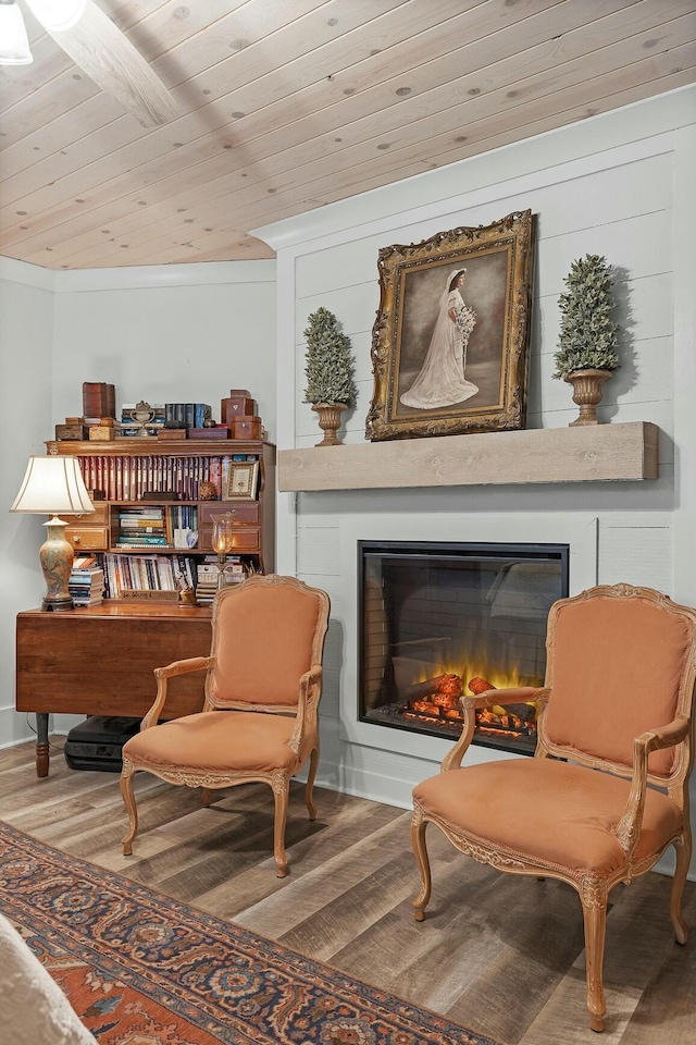 sitting room with hardwood / wood-style flooring and wood ceiling