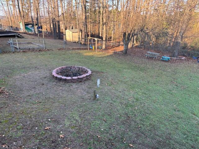 view of yard with a fire pit