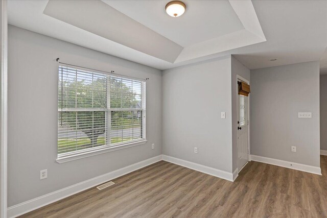 242 Mulberry Ln NE, Cleveland, TN 37312 - spare room with a tray ceiling and wood finished floors