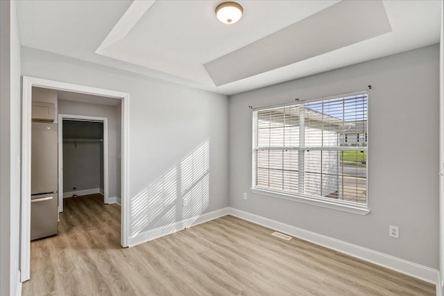 242 Mulberry Ln NE, Cleveland, TN 37312 - unfurnished room with a raised ceiling and light wood-style floors