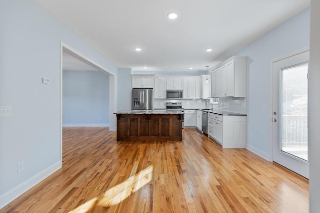 605 Westover Dr SW, Cleveland, TN 37311 - kitchen with stainless steel appliances, light wood finished floors, white cabinetry, decorative backsplash, and recessed lighting
