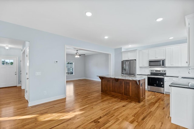 605 Westover Dr SW, Cleveland, TN 37311 - kitchen with stainless steel appliances, a center island, healthy amount of natural light, light wood-style floors, and recessed lighting