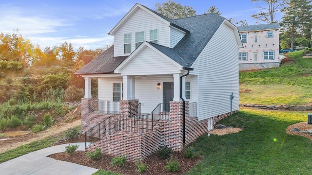 605 Westover Dr SW, Cleveland, TN 37311 - view of front of house featuring covered porch, a front lawn, and roof with shingles