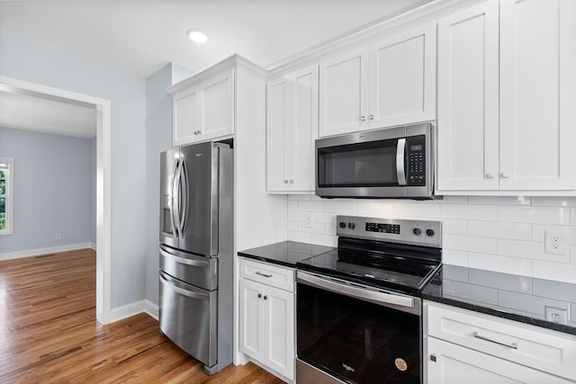 605 Westover Dr SW, Cleveland, TN 37311 - kitchen featuring appliances with stainless steel finishes, white cabinetry, backsplash, light wood-style floors, and recessed lighting
