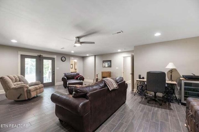 living room featuring ceiling fan and french doors