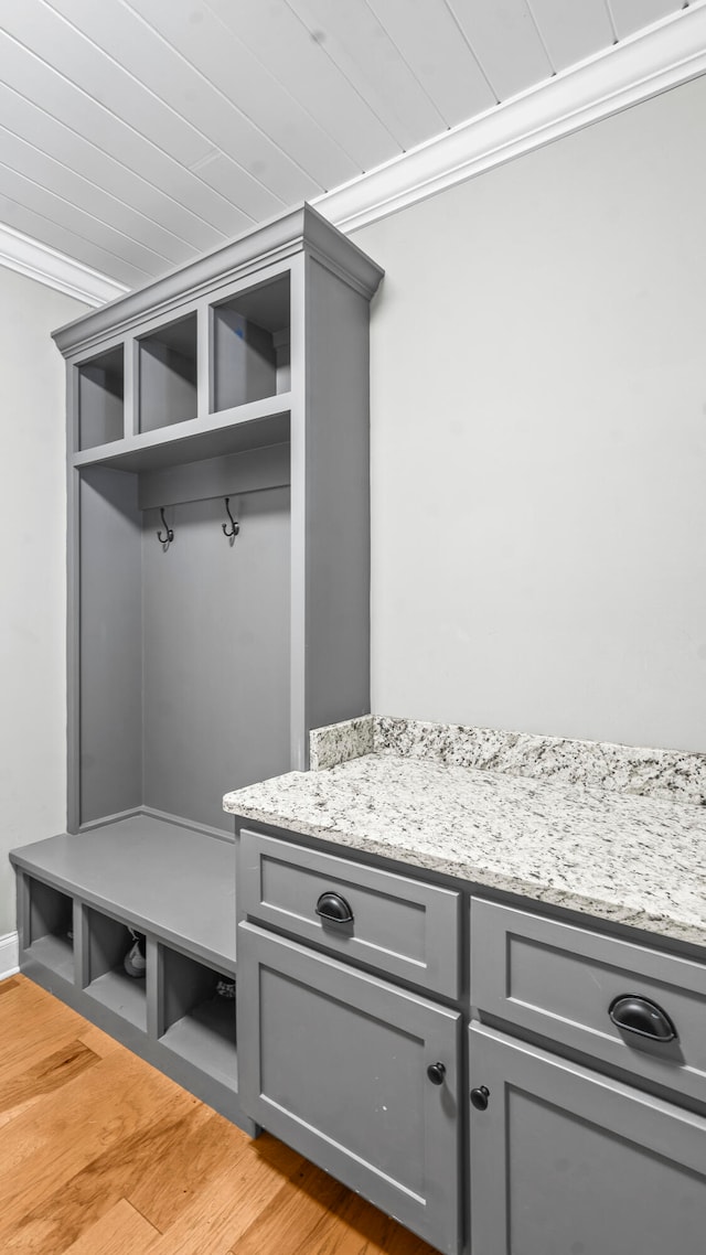 mudroom with light hardwood / wood-style floors, ornamental molding, and wooden ceiling