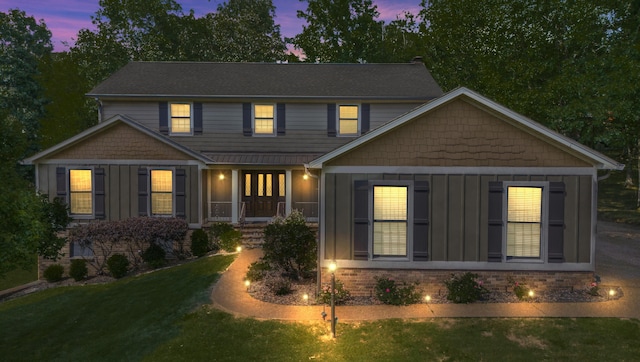 view of front of home with a porch and a yard