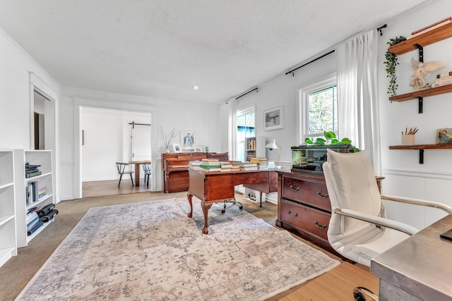 home office featuring carpet and a textured ceiling