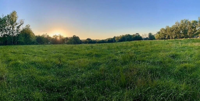 nature at dusk featuring a rural view