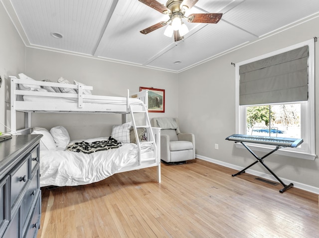 bedroom with a ceiling fan, visible vents, light wood-style floors, and baseboards