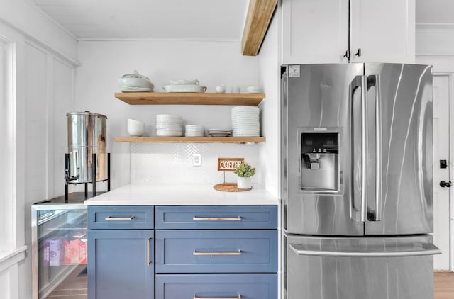 kitchen featuring open shelves, stainless steel fridge with ice dispenser, ornamental molding, light countertops, and backsplash