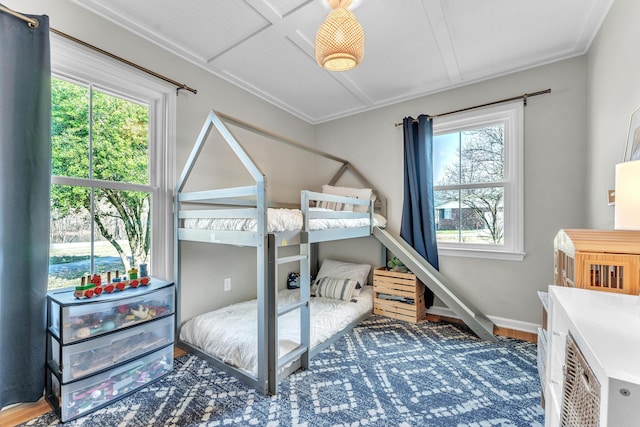 bedroom with baseboards and wood finished floors