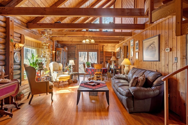 living room featuring wood ceiling, beamed ceiling, rustic walls, a notable chandelier, and hardwood / wood-style flooring