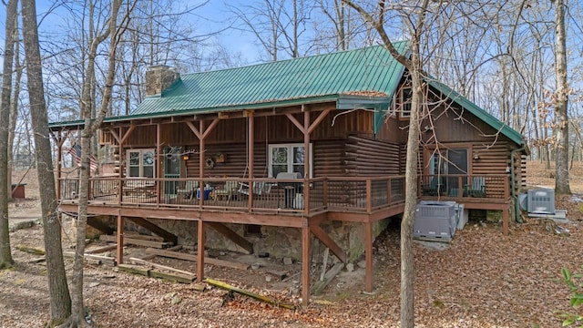 back of house with a wooden deck and cooling unit