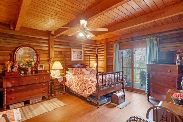 bedroom featuring beamed ceiling, light hardwood / wood-style floors, rustic walls, access to outside, and ceiling fan