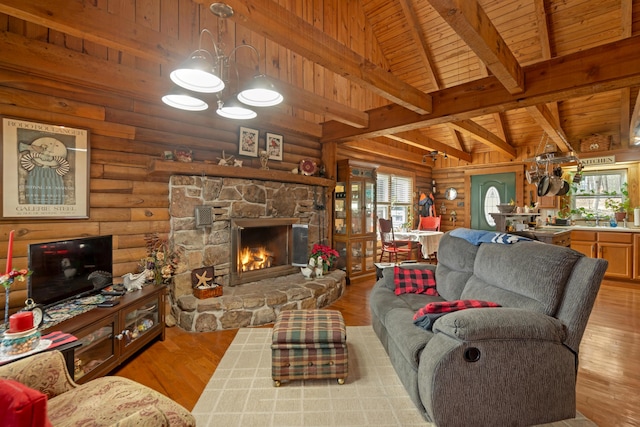 living room featuring wooden ceiling, a stone fireplace, rustic walls, and light hardwood / wood-style flooring