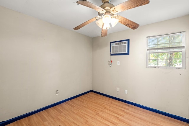 unfurnished room with light hardwood / wood-style flooring, ceiling fan, and a wall unit AC