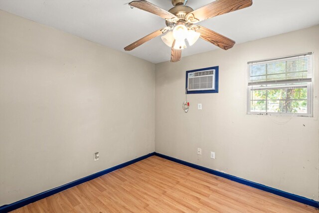 unfurnished room with light hardwood / wood-style flooring, ceiling fan, and a wall unit AC