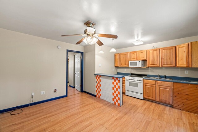 kitchen featuring white appliances, ceiling fan, sink, decorative light fixtures, and light hardwood / wood-style floors