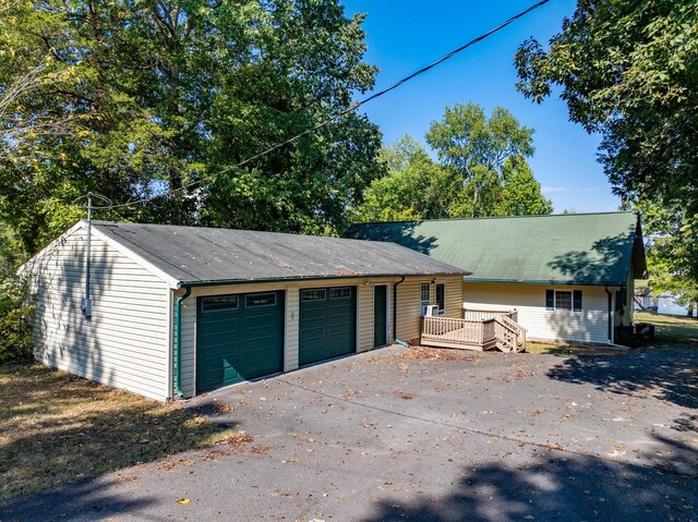 ranch-style home with a garage and a wooden deck