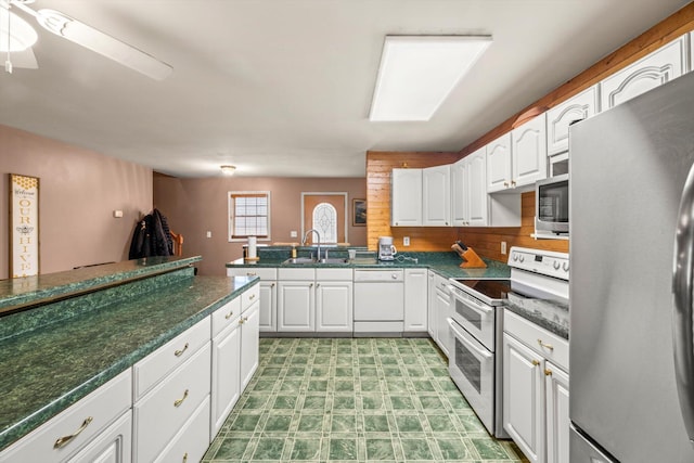 kitchen featuring kitchen peninsula, white cabinetry, sink, and stainless steel appliances