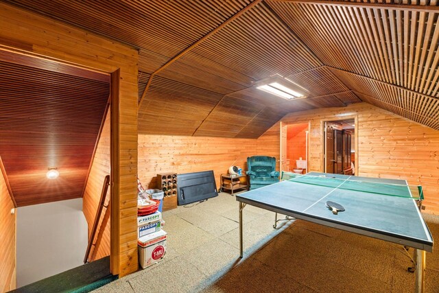 game room featuring wood walls, carpet, wooden ceiling, and lofted ceiling