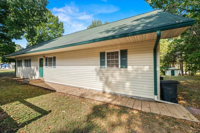 view of side of home with a yard