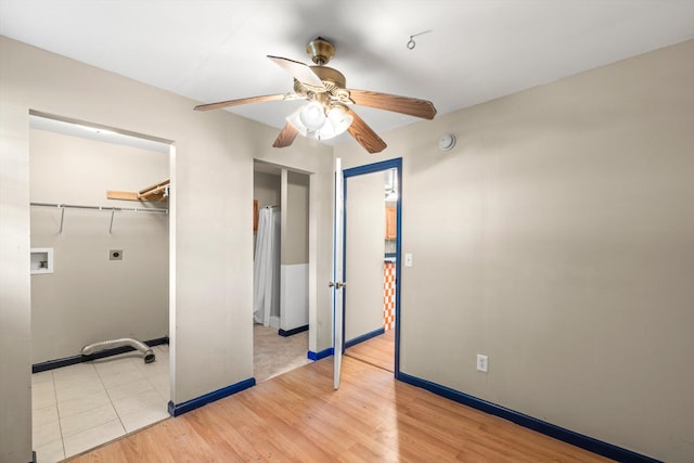 unfurnished bedroom with a closet, light hardwood / wood-style flooring, and ceiling fan