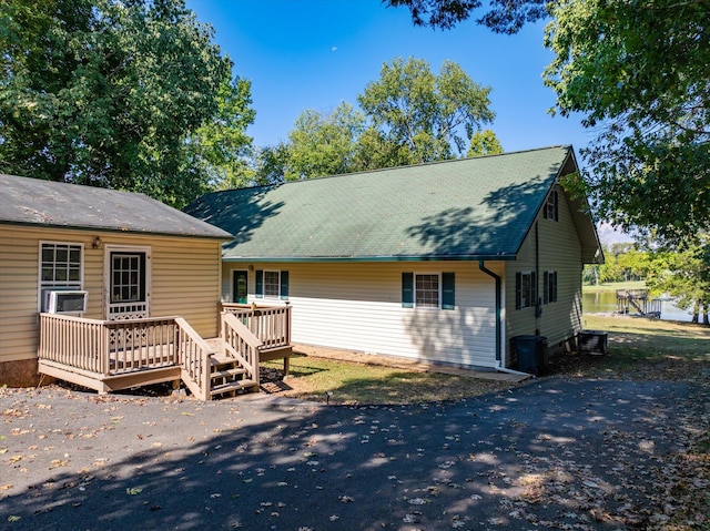 back of property featuring a wooden deck and central AC