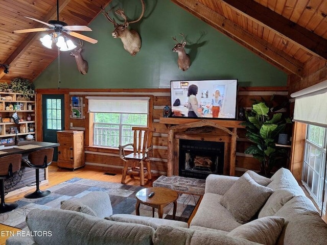 125 Hiwassee Cir, Reliance, TN 37369 - living area featuring wooden ceiling with exposed beams, wood finished floors, plenty of natural light, a fireplace with raised hearth, and a ceiling fan