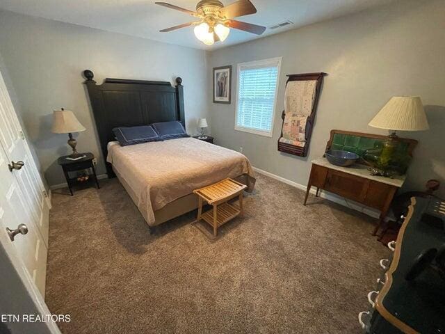 bedroom featuring ceiling fan and dark colored carpet