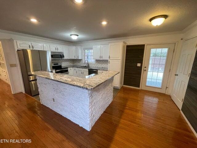 kitchen with white cabinetry, stainless steel appliances, dark wood-type flooring, and sink