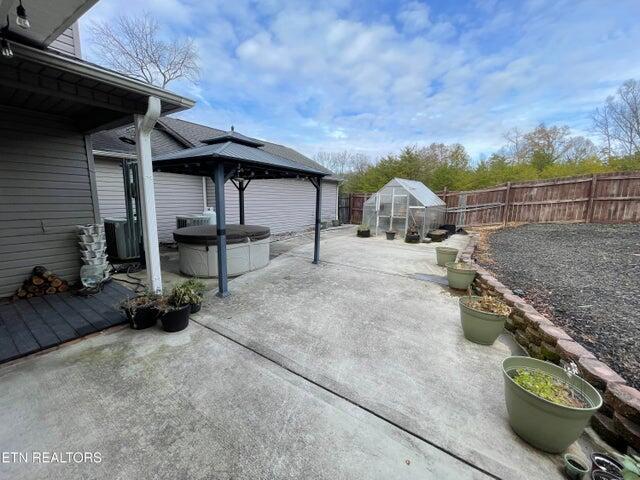 view of patio / terrace featuring a gazebo and an outdoor structure