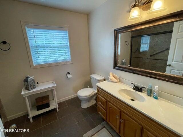 bathroom with tile patterned flooring, vanity, and toilet