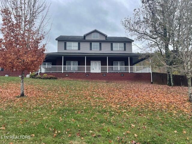 country-style home with a front lawn